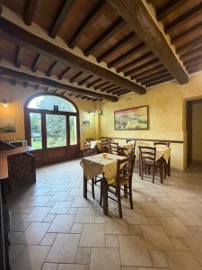 a dining room with tables and chairs and a window at B&B Fonte dei Tufi in Siena