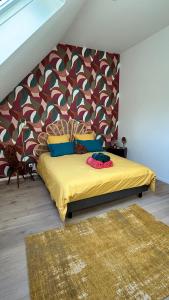 a bedroom with a bed with a colorful headboard at Casa Mypi in Reinhardsmunster +28 photos