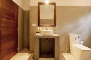 a bathroom with a sink and a toilet and a mirror at Haru Ahangama in Ahangama +57 photos