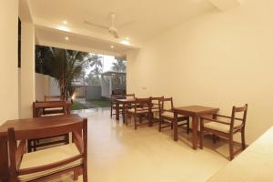 a dining room with wooden tables and chairs at Haru Ahangama in Ahangama