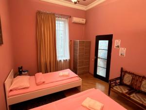 a small room with two beds and a window at Bridge House Yerevan Armenia in Yerevan