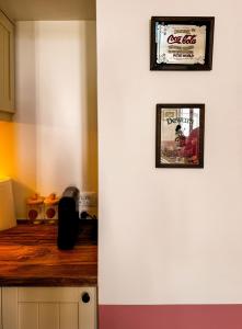 a white wall with two framed pictures on it at Arbarorisa Traditional Suites in Mesaria