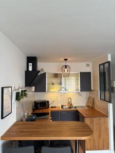a kitchen with a wooden counter top in a room at Studio à Gaillard in Gaillard