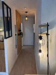 a hallway with two lights on the wall and a hallway with a hallway at Studio à Gaillard in Gaillard