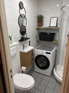 a bathroom with a washing machine and a toilet at Studio à Gaillard in Gaillard +1 photo