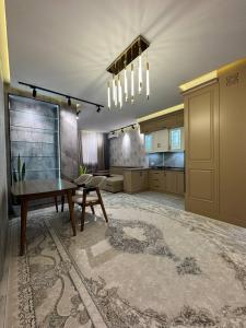 a large kitchen with a table and a dining room at White Guest House in Samarkand +1 photo