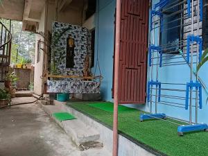 a house with a green floor and a red door at Bijoy Villa in Guwahati