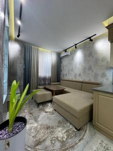 a living room with a couch and a table at White Guest House in Samarkand