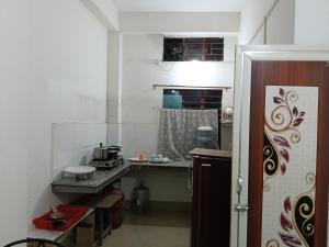 a small kitchen with a counter in a room at Bijoy Villa in Guwahati