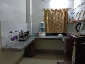 a kitchen with a counter with a coffee maker on it at Bijoy Villa in Guwahati +4 photos
