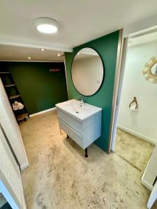 a bathroom with a white sink and a mirror at Grand studio avec terrasse in Saint-Marcel-lès-Valence