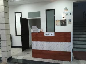 a reception desk in a building with a sign that reads reception at Prince Vatika in Alwar