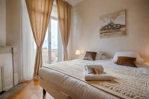 a bedroom with a large bed with a large window at Appartement Vaste Horizon - LRA Cannes in Cannes