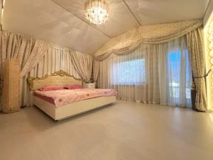 a bedroom with a bed and a chandelier at Вілла з басейном in Novosëlovka +49 photos