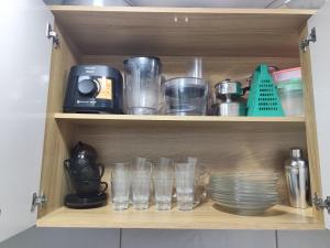 a wooden shelf with glasses and a blender on it at Haurea House in São Luís +9 photos