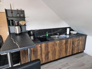 a kitchen with a sink and a counter top at Moderne Ferienwohnung in Hainichen in Hainichen