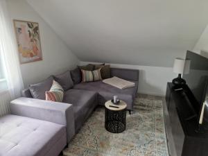 a living room with a couch and a table at Moderne Ferienwohnung in Hainichen in Hainichen