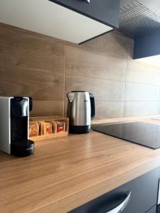 a coffee maker on a wooden counter in a kitchen at Katrina's Home alloggio turistico in Fiumicino