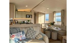 a living room with a couch and a table at Sunset Bay Aberaeron in Aberaeron