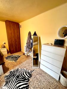 a room with a mirror and a zebra print rug at Da Ersilia in Cernobbio