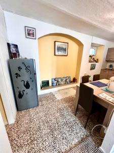 a kitchen with a refrigerator in a room with a table at Da Ersilia in Cernobbio