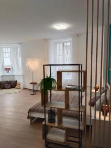 a living room with a shelf in the middle of a room at Leier apartments in Piešťany