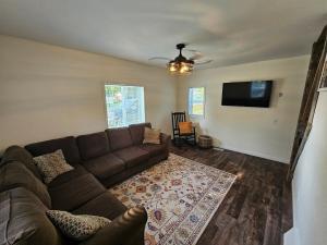 a living room with a couch and a flat screen tv at Moores Crystal Mountain Retreat in Thompsonville
