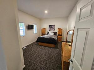 a bedroom with a bed and a television in it at Moores Crystal Mountain Retreat in Thompsonville