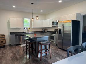 a kitchen with a refrigerator and a table and chairs at Moores Crystal Mountain Retreat in Thompsonville