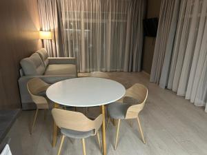 a living room with a table and chairs and a couch at Fisherman in Kyiv