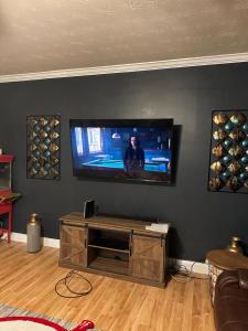 a living room with a flat screen tv on a wall at Country house in Covington