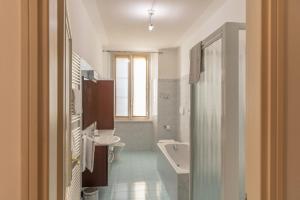 a bathroom with a toilet and a sink and a tub at Appartamento Bianca in Bellagio +42 photos