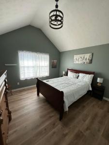 a bedroom with a large bed and a chandelier at Country house in Covington