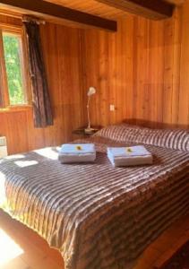 a bedroom with a bed with two towels on it at Relax alpino con sauna - Ca da Viola in Cavagnago
