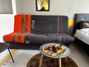 a living room with a couch and a table with a cake at Gwada dream in Saint-François +40 photos