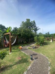 a garden with a hammock and a swing at La Posada de Sofi in Concordia