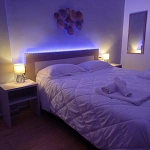a bedroom with a large bed with a blue light at Luxury Rooms Bari in Bari