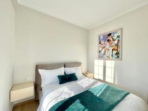 a bedroom with a bed and a painting on the wall at Villa Safira in Durrës