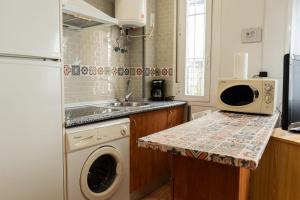 a kitchen with a washing machine and a sink at Luz del Guadiana in Ayamonte