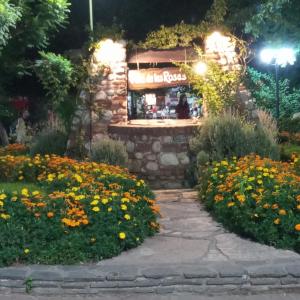 a flower garden in front of a flower shop at night at casitadearminda-II in Villa Las Rosas