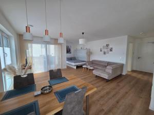 a living room with a couch and a table at Panorama Apartments in Füssen
