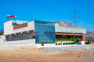 a building with a sign for a sandwich shop at Vihari Foodway Inn in Jāmb