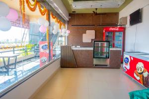 a fast food restaurant with a coca cola machine at Vihari Foodway Inn in Jāmb