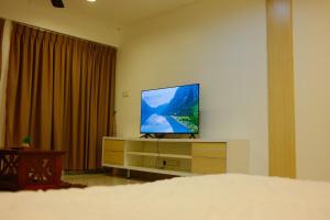a television sitting on a dresser in a bedroom at UrbaNest in Kota Bharu