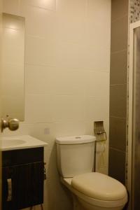 a bathroom with a toilet and a sink at UrbaNest in Kota Bharu +26 photos