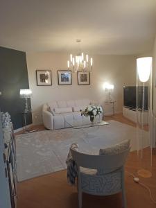 a living room with a white couch and a television at villa josepha in Cournon-dʼAuvergne