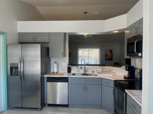 a kitchen with white cabinets and stainless steel appliances at Joel's Place in Lake Wales