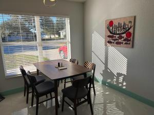 a dining room with a wooden table and chairs at Joel's Place in Lake Wales