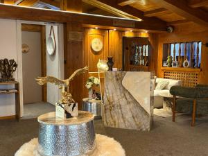 a living room with a table with a painting on it at Le Chalet d'Antoine - Centre de Megève in Megève +66 photos