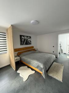 a bedroom with a large bed and a window at Casa Apartament Refugiul Dornean in Vatra Dornei